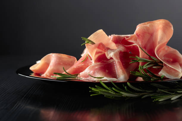 istock Italian prosciutto or Spanish jamon with rosemary. 1476198982