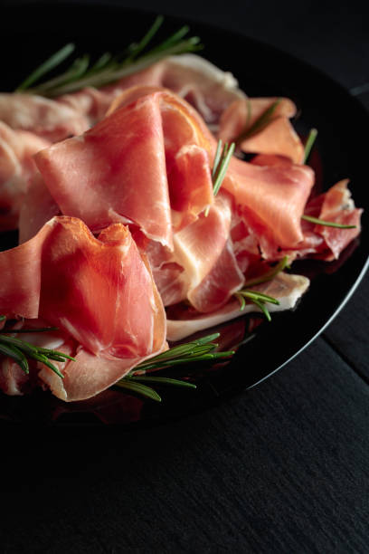 istock Italian prosciutto or Spanish jamon with rosemary. 1476199009