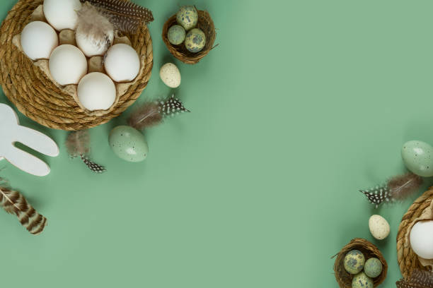 istock Easter holiday concept with white eggs and decoration on green background. Top view, flat lay 1476200791