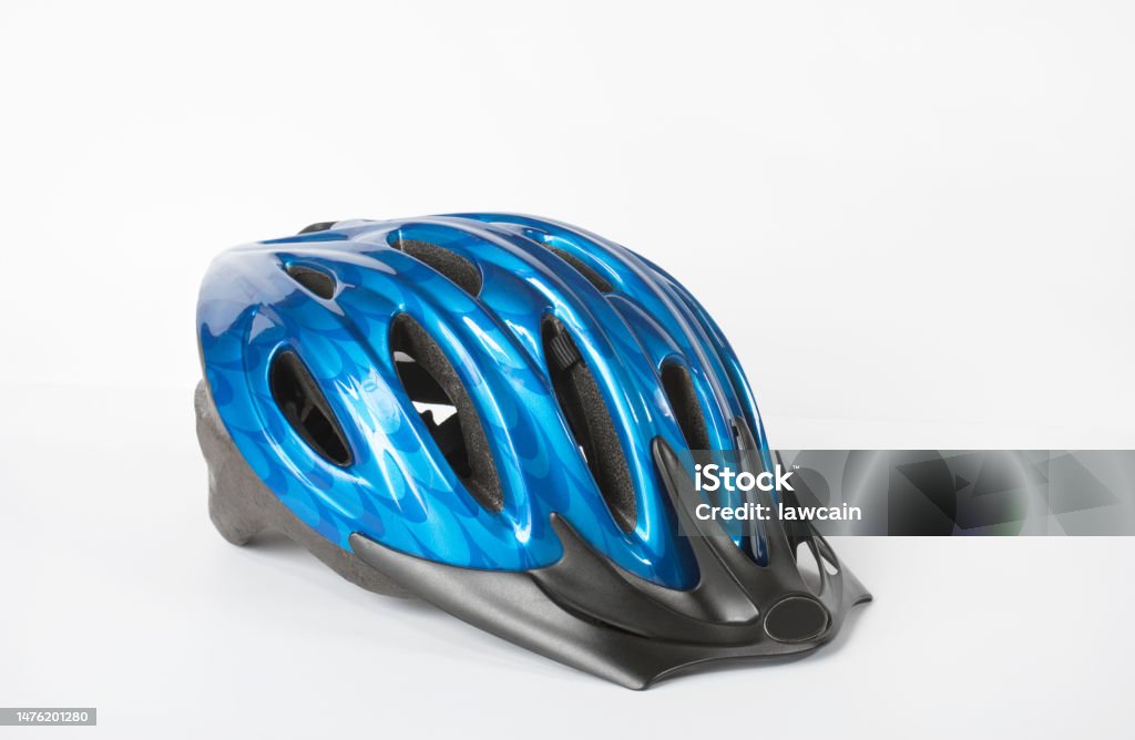 Blue and Black Bicycle Helmet on White Blue bicycle sports helmet with black accents isolated on white background. Cycling Helmet Stock Photo