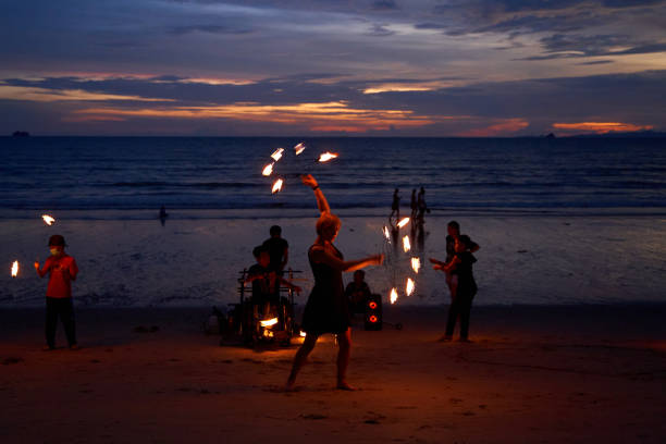 young latin woman fire performer holds in her hands fire fans over her head portrait