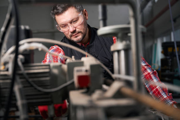 istock Adult worker processing metal structures, manufactures products 1476206377