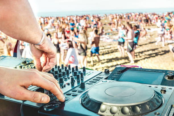 Detail of dj playing modern sound on cd usb player at spring break festival - Beach music party and life style concept - Defocused background with shallow depth of field - Bright vivid filter stock photo