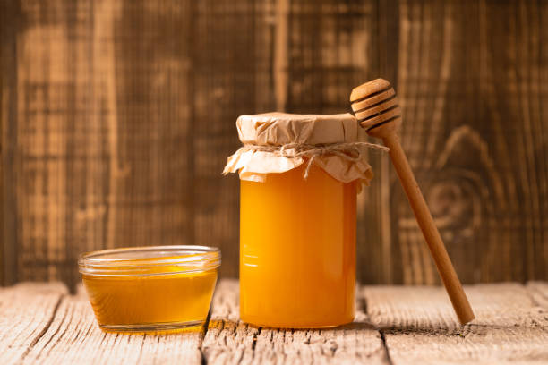 istock Honey on a wooden background 1476212786