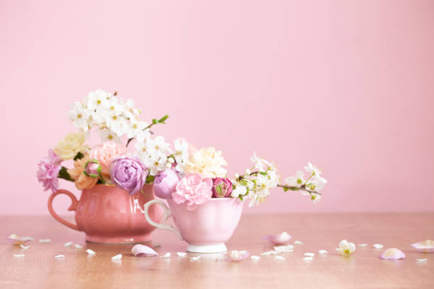 istock beautiful spring flowers in two vintage cups on pink background 1476220320