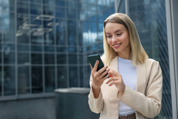 istock Long-haired blonde woman with a phone in hand 1476222831