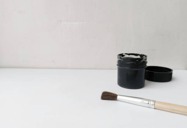 istock Brush and can with black paint on a white background. The paint is open. Everything for drawing. Creation. Children are creativity. Hobby. Colored paints and gouache. 1476227458
