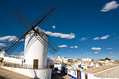 Ancient windmills near houses in Campo de Criptana, Spain, defined in Cervantes' Don Quixote 