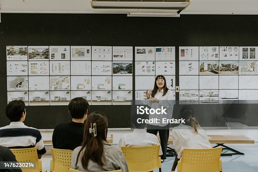 istock Active asian girl is practices present her final thesis to her friends before present to professor. 1476230214