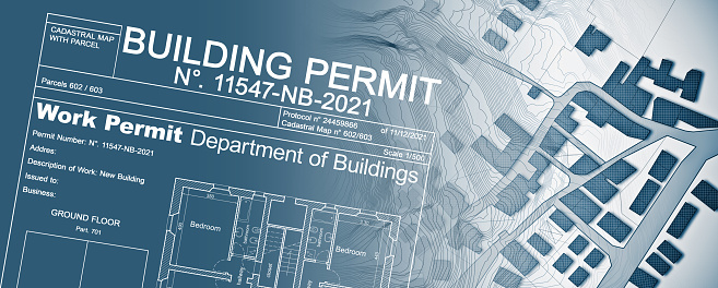 Buildings Permit concept with imaginary cadastral map - building activity and construction industry concept with city map and building work permission