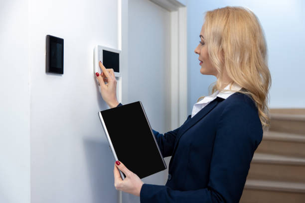 istock Concentrated young female adjusting the home automation 1476235520