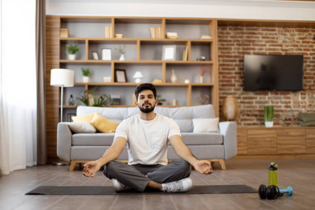 istock Indian man practicing meditation in lotus pose at home 1476237093