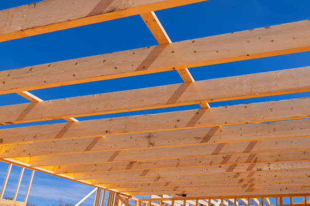 istock During the construction of a new wooden structure, a framing beam supports the framework construction of the layout of the joists. 1476239283
