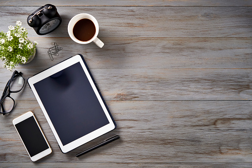 New year resolutions theme: Top view of Notepad, smartphone, digital tablet and sticky notes on a table with copy space