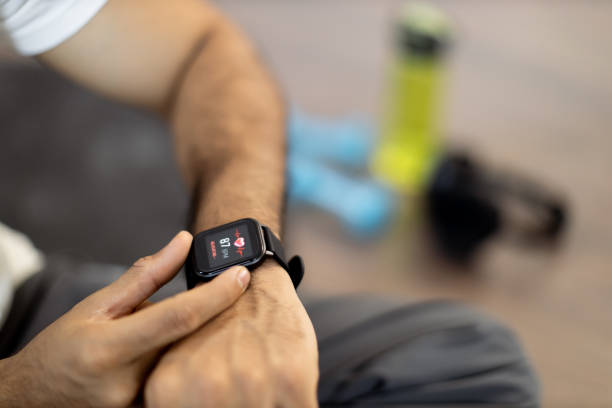 istock Sporty man checking pulse on smartwatch after workout inside 1476239884