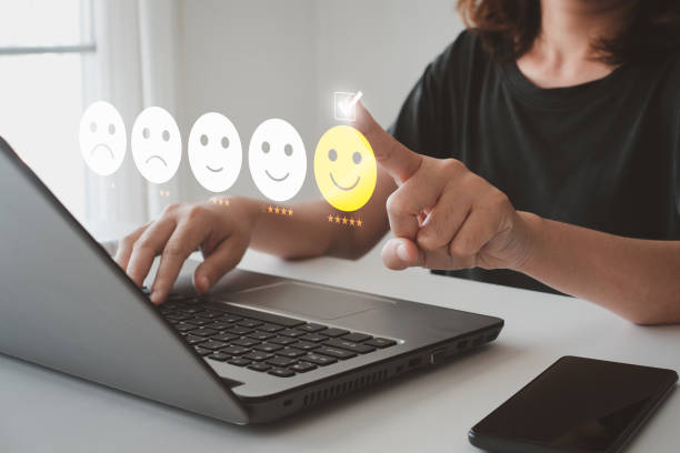 istock Client's hand ticked the happy face smile face, Customer service evaluation and satisfaction survey concept. User give rating to service experience on online application for Customer review feedback. 1476243075