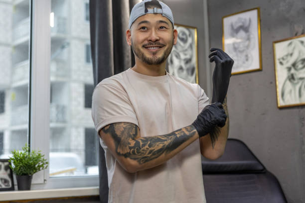 Young asian man putting on gloves