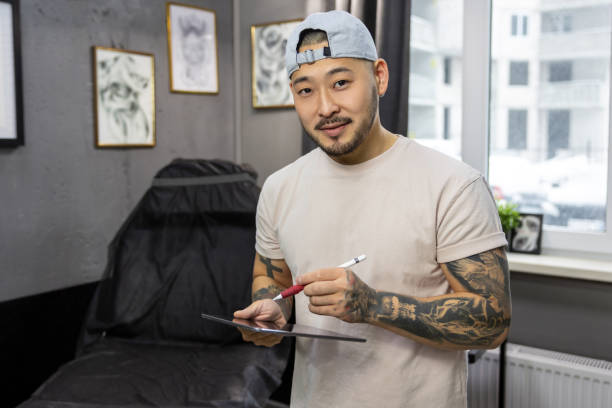 istock Tattoo master working on new ideas and looking excited 1476245930