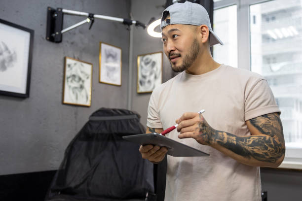 istock Tattoo master working on new ideas and looking excited 1476245932