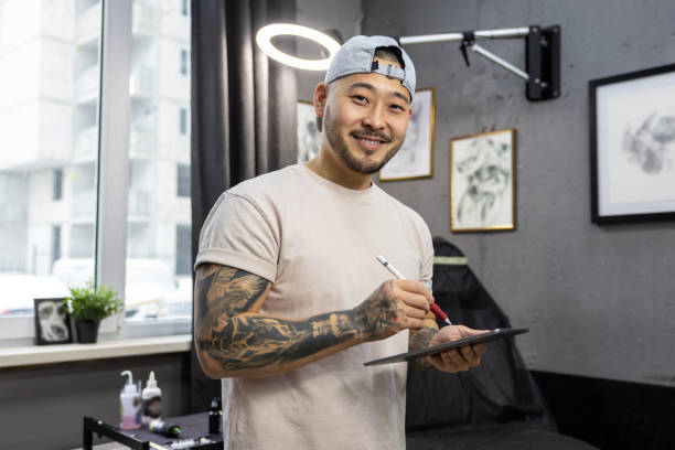 istock Tattoo master working on new ideas and looking excited 1476245935