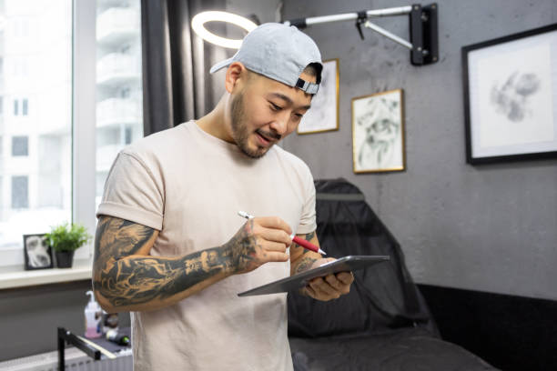 istock Young asian tattoo salon owner feeling good at his workplace 1476245941