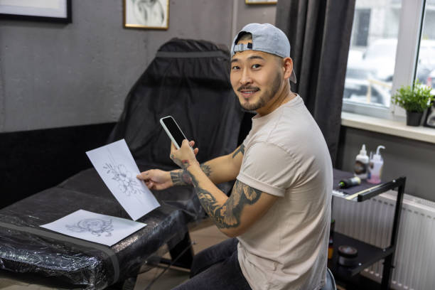 istock Young asian tattoo salon owner feeling good at his workplace 1476245943