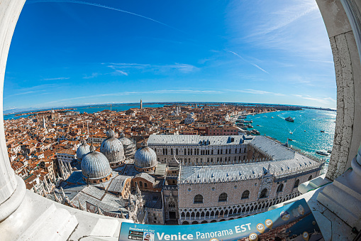 Venice: Venice panorama East from the height of Campanile San Marco tower, with the Basilica San Marco and Palazzo Ducale in foreground, rooftops and the sea in  background.