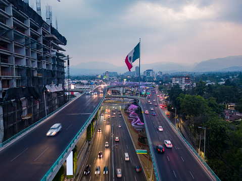 Mexico City south skyline along the Periférico Sur ring road, with monumental flag