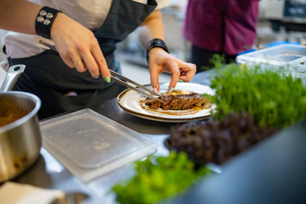 istock Chef cooking Roasted Duck breast fillets with vegetable pure on restaurant kitchen 1476254239