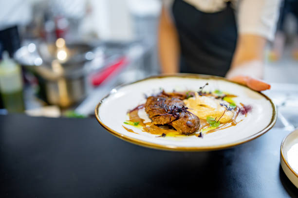 istock Chef cooking Roasted Duck breast fillets with vegetable pure on restaurant kitchen 1476254243
