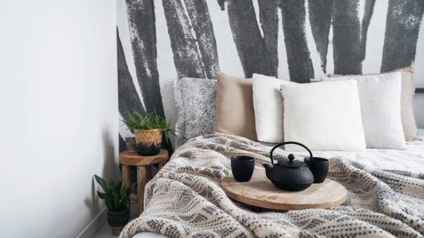 istock brewing tea in ceramic mugs on bed with blanket and cushions in boho style 1476254256