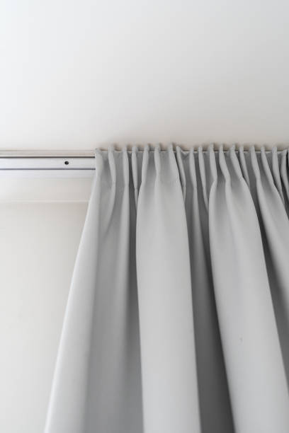 istock curtain hanging on ceiling rod in bedroom 1476254532