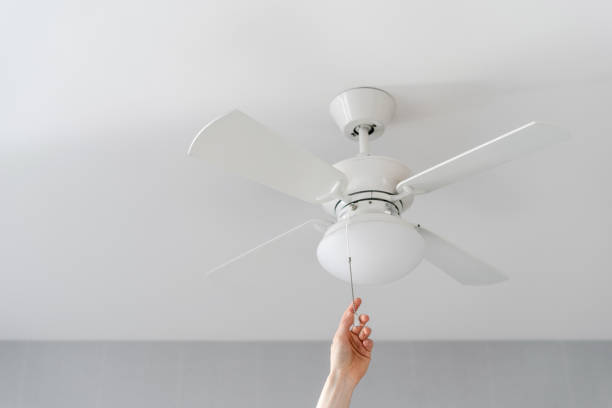 istock person turn on electric ceiling lamp with propeller indoors 1476254533