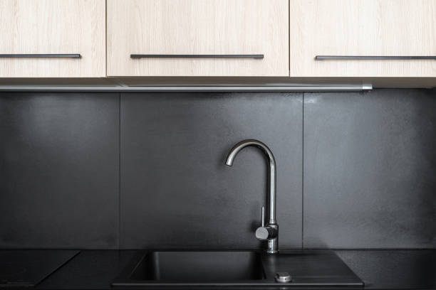 istock chrome water tap and sink at modern apartment 1476254700