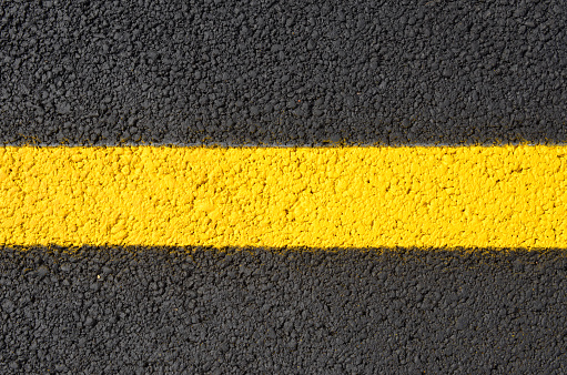 A yellow line in pavement street