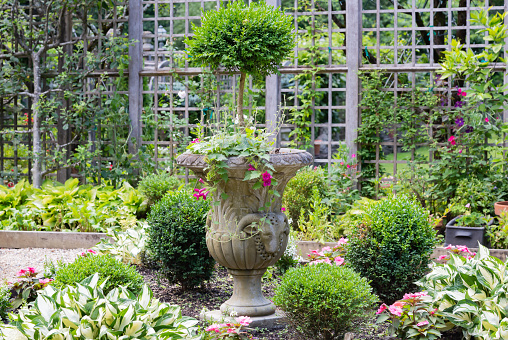 Lovely garden highlighting an ornate stone planter.