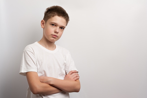 A boy model posing in a white t-shirt