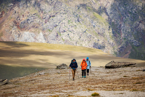 Three friends trekking in mountains