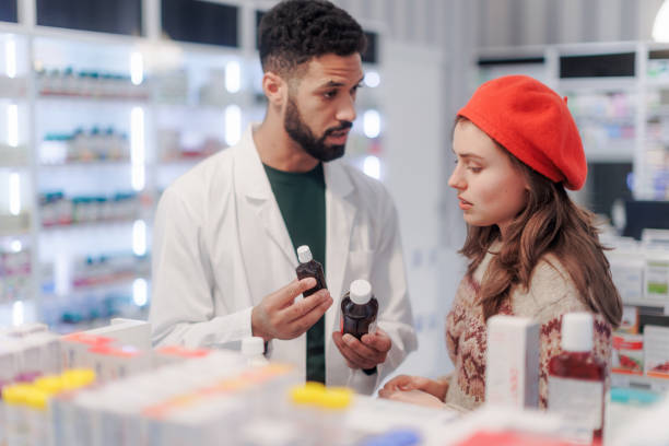istock Young pharmacist helping customer to choos medication. 1476261034