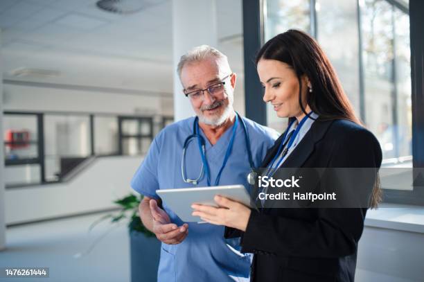Young Pharmaceutic Seller Explaining Something To Doctor In Hospital Stock Photo - Download Image Now