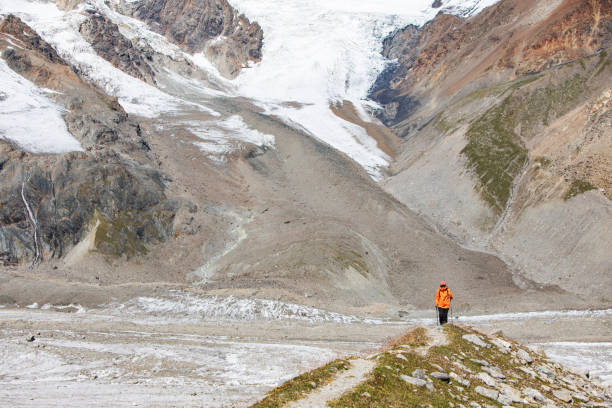 istock One young woman trekking in mountains 1476262327