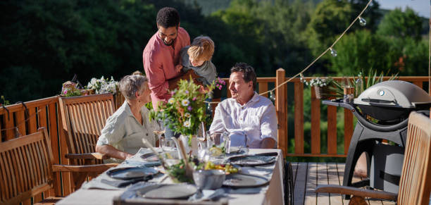 istock Multi generation family party outside in the backyard on patio. 1476262468