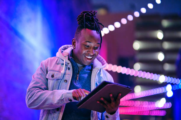 istock Young Man Using a Digital Tablet in a City at Night 1476264587