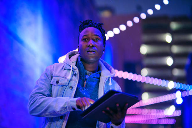 istock Young Man Using a Digital Tablet in a City at Night 1476264608
