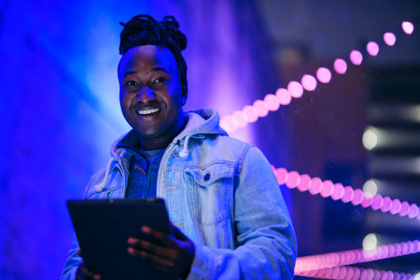 istock Young Man Using a Digital Tablet in a City at Night 1476264654