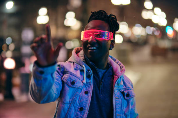 Young Man Wearing Virtual Glasses in a City at Night