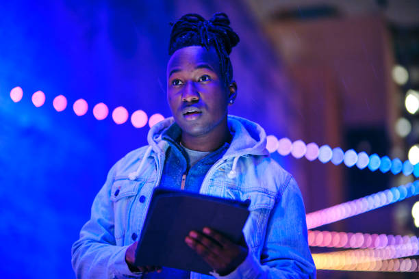 istock Young Man Using a Digital Tablet in a City at Night 1476264776