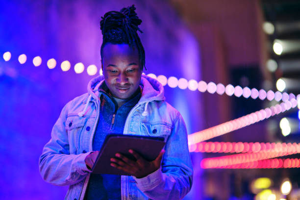 istock Young Man Using a Digital Tablet in a City at Night 1476264838