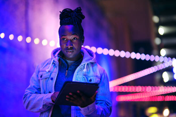 istock Young Man Using a Digital Tablet in a City at Night 1476264929