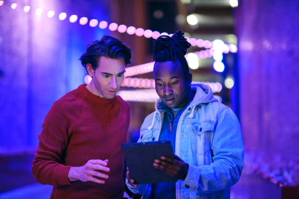istock Young Men Using a Digital Tablet in a City at Night 1476265090